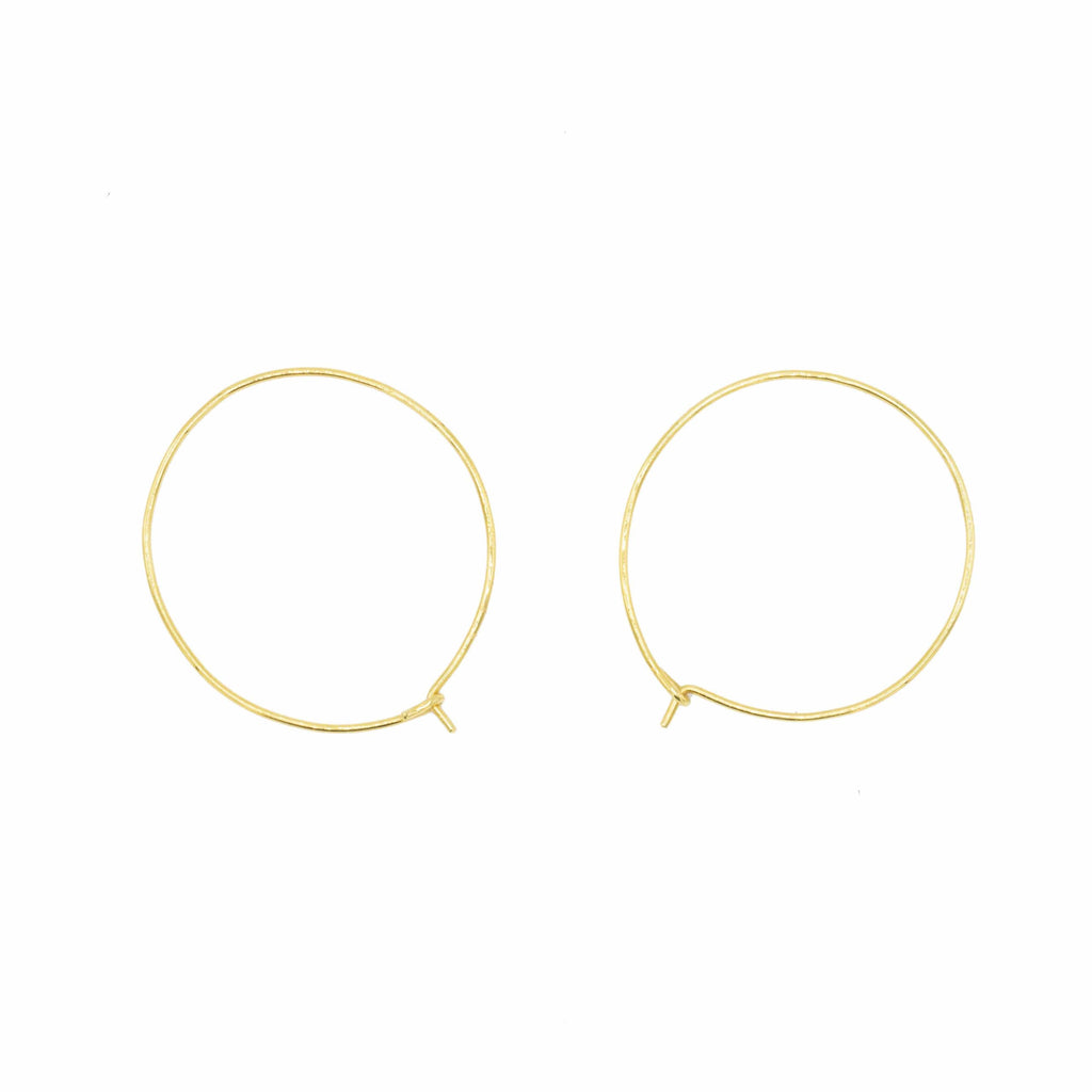 Close up of the simple yet elegant 14kt hoops from Stoned Jewelry